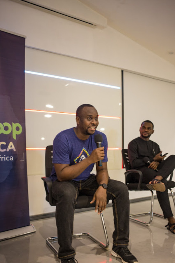 Aniedi taking questions from the audience while Prosper looks on.